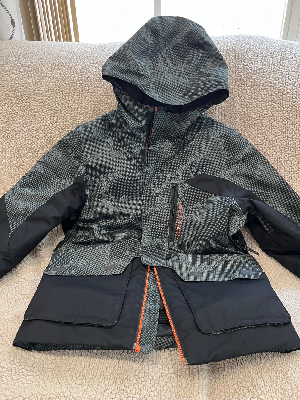 Obermeyer Kids Hooded Rain Jacket in Gray Camo with Orange Accents